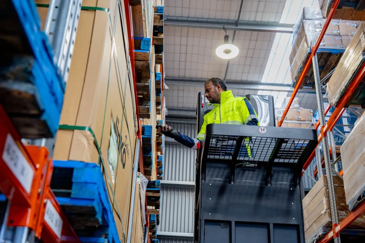 Warehouse operator scanning returned goods during inspection and grading