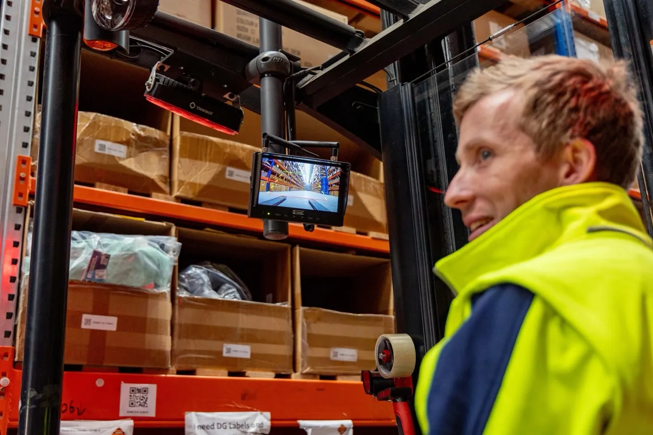 Warehouse supervisor checking forklift activity as part of scale and process discipline